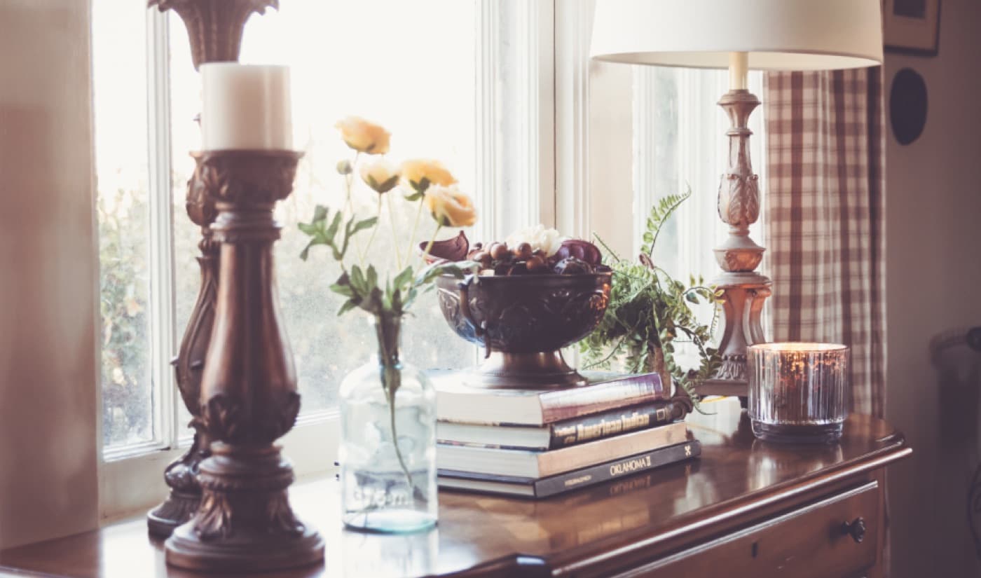 Candles and flowers arranged on a mantelpiece